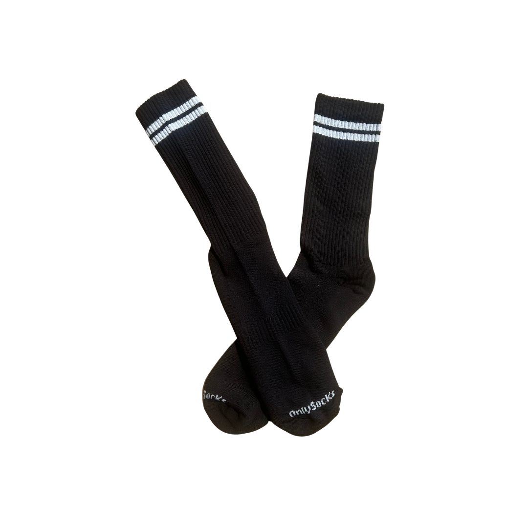 A pair of black crew socks with white stripes near the cuffs and white 'onlysocks' branding printed on the toes.
