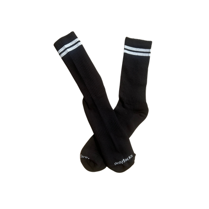 A pair of black crew socks with white stripes near the cuffs and white 'onlysocks' branding printed on the toes.