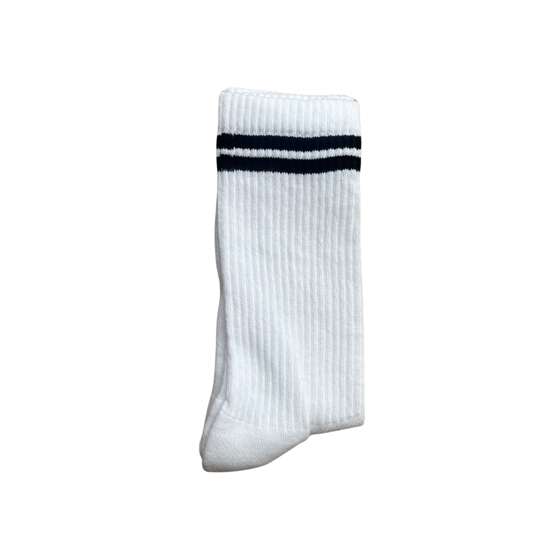 A single white ribbed crew sock with two dark black stripes near the cuff