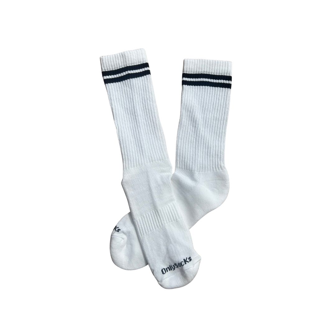 A pair of white ribbed crew socks with two black stripes near the cuff and the brand name 'Onlysockss' printed in black on the toe.