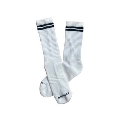 A pair of white ribbed crew socks with two black stripes near the cuff and the brand name 'Onlysockss' printed in black on the toe.